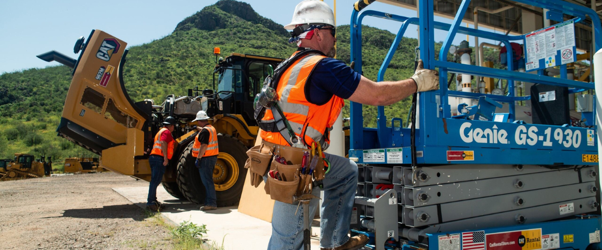 Three workers and Cat rental equipment on job site