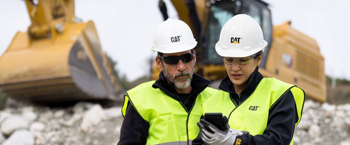 Two workers looking at digital assets on an construction job site