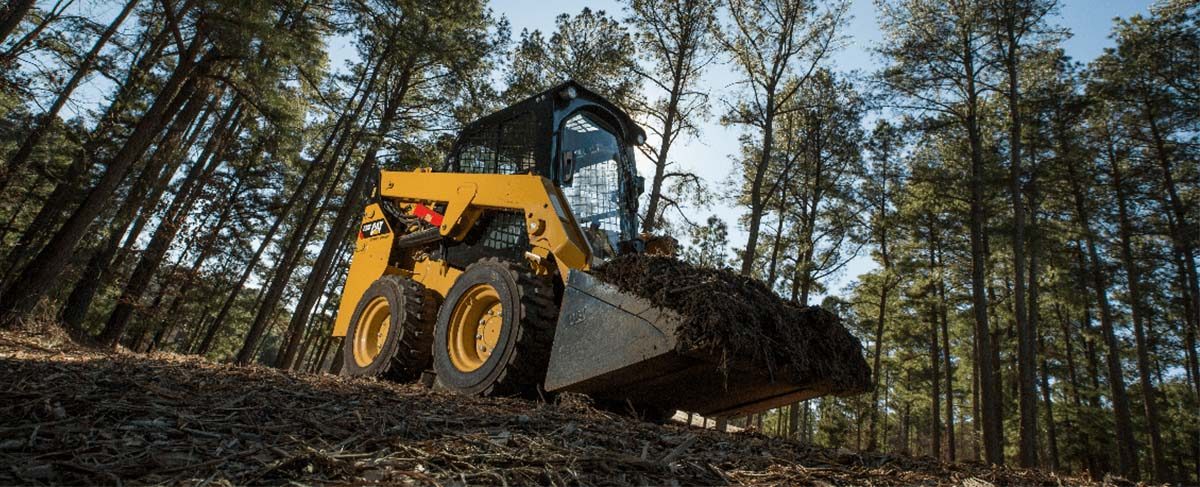 skid steer picking up dirt 